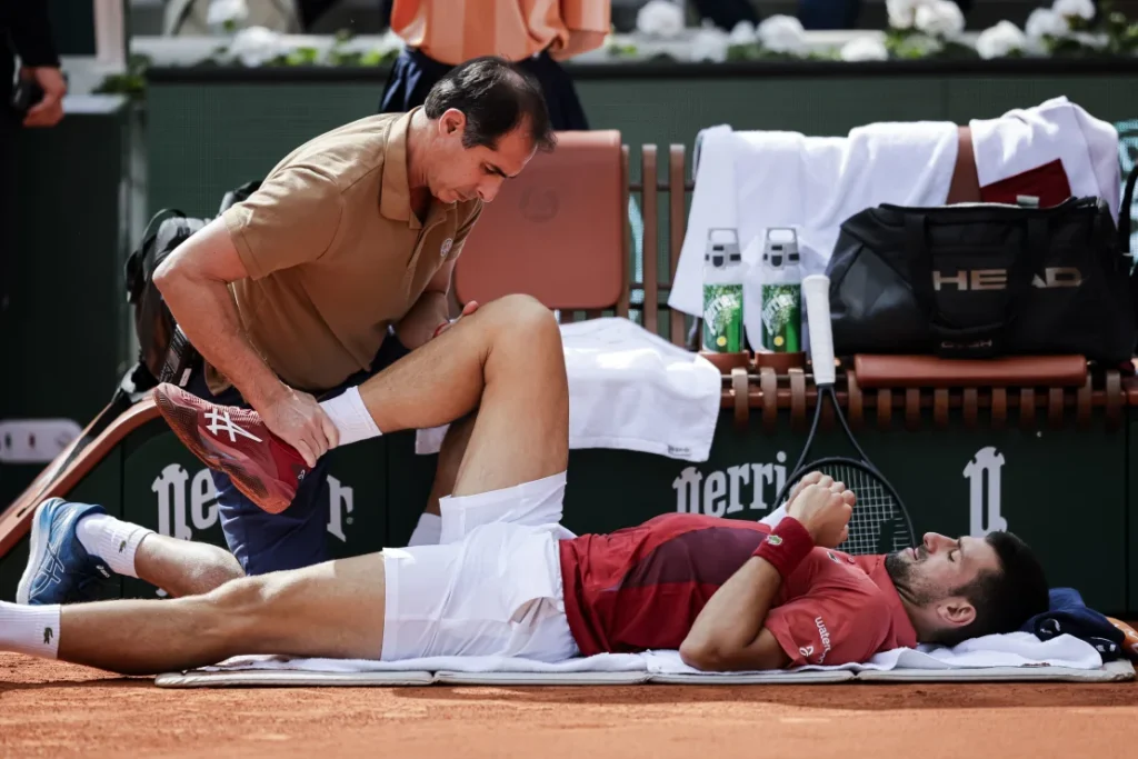 Djokovic receives treatment to his knee during the victory against Cerúndolo. Antonio Borga/Eurasia Sport Images/Getty Images